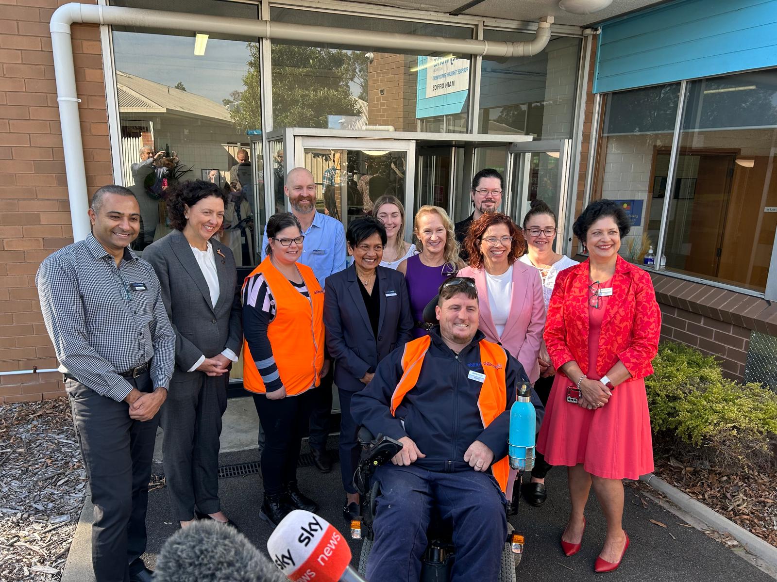 A group of cheerful Ability Works’ staff and two of our Team leaders pose with Minister Rishworth during their visit in April.