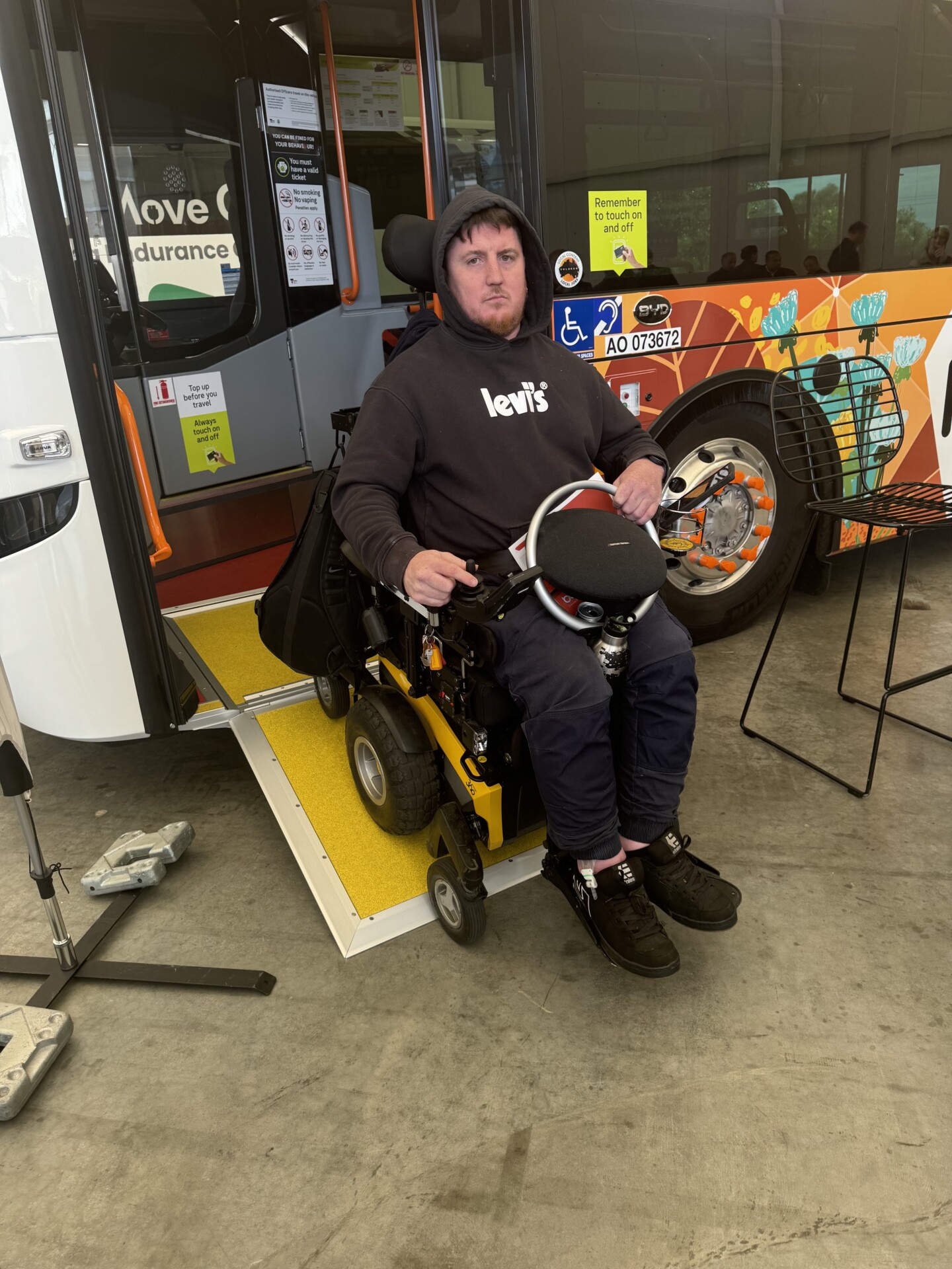 Mark, who uses a wheelchair, is testing the new zero-emission bus by using the ramp